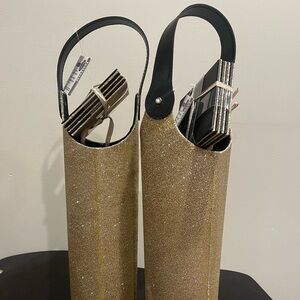 Two gold glitter wine bottle holders with coasters